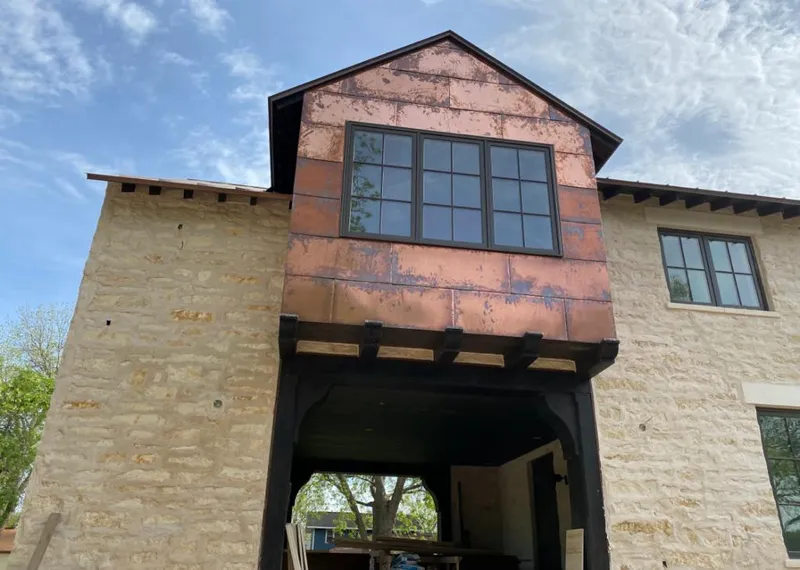 Copper metal panel facade on a stone building for Skylight Installation in Freeport